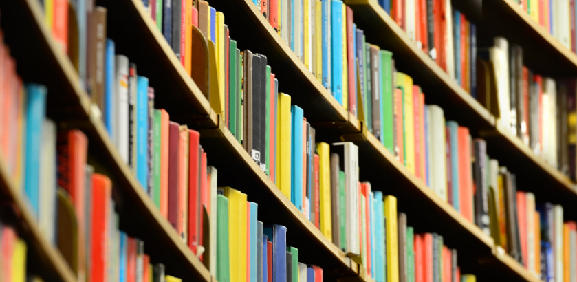 Curved bookshelf full of colourful books