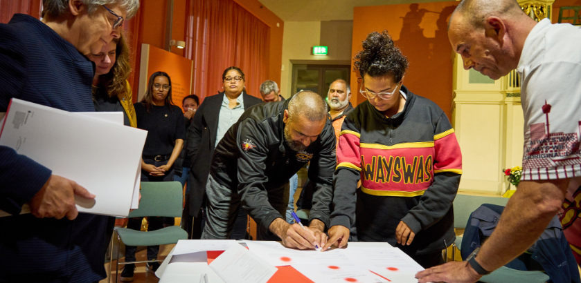 Community representatives signing formal handover documentation at the Grassi Museum with Dr Birgit Scheps-Bretschneider at the Grassi Museum.