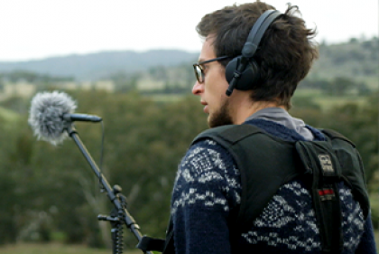 AFTRS image of male with an audio setup of mic and headphones.