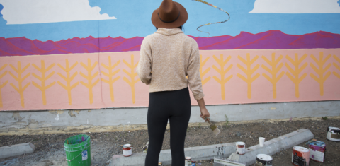 Artist looking at wall art