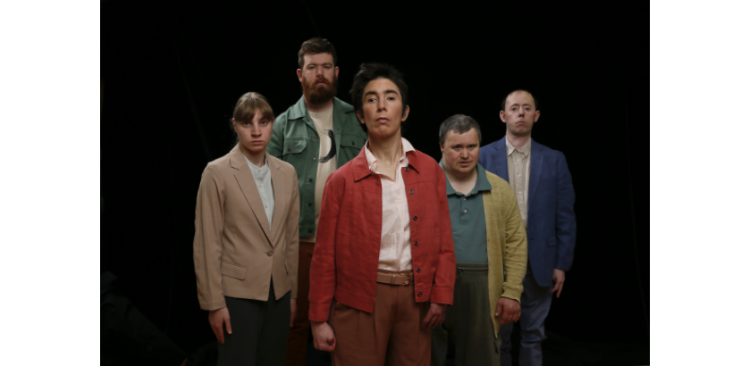 Five members of Back to Back Theatre company stand against a black background.