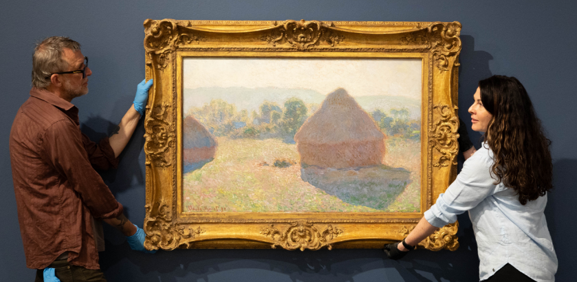 Art technician Chas Glover and Tweed Regional Gallery Curator - Exhibitions Tina Wilson hanging Claude Monet's masterpiece 'Meules, milieu du jour [Haystacks, midday]', 1890, as part of the National Gallery of Australia's Sharing the National Collection initiative. Photo by Luke Marsden.