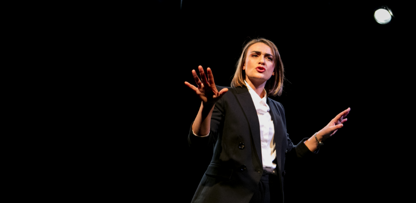 Performer on stage under the bright stage lights. Image supplied by Griffin Theatre Company Limited.