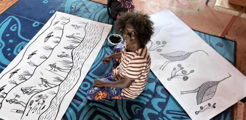 Jay Jurrupula Rostron with two new 2022-2023 screen print designs ‘Galk and Namurre Boko’ during workshop with Bobbie Ruben in 2022 (Bawinanga Aboriginal Corporation).