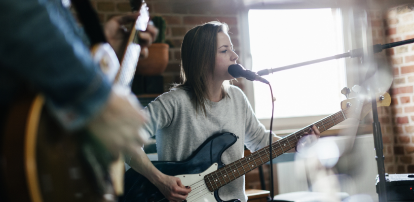 musician playing guitar and singing