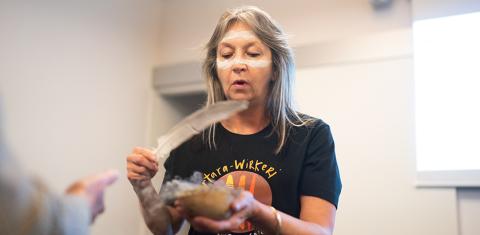 Robyn Campbell of South East First Nations of South Australia performing smoking ceremony at Oxford Museum of Natural History