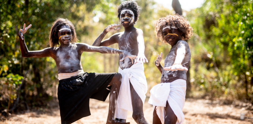 Three young Balkarranga clan members posing outside, ready to perform.