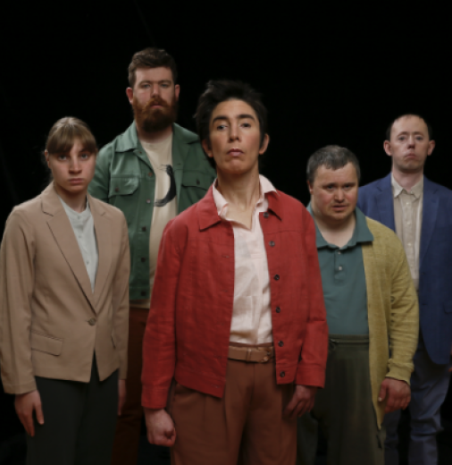 Five members of Back to Back Theatre company stand against a black background.