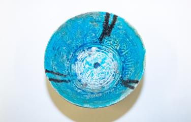 Islamic bowl with turquoise glaze and black inscription in Nasta’liq script wishing health and prosperity to its owner.